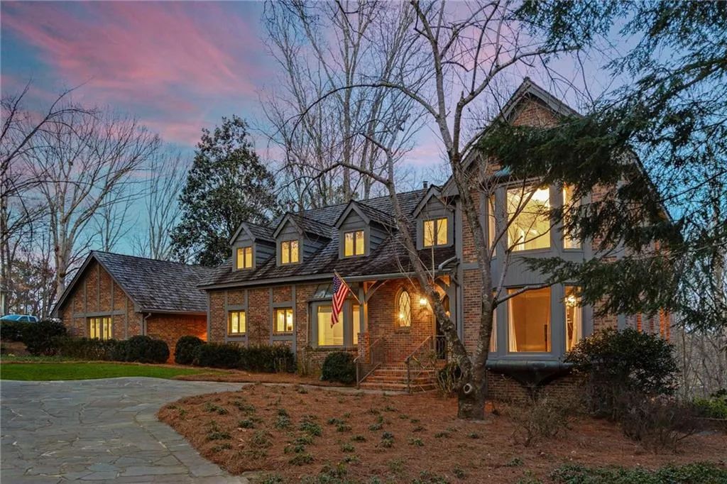 Charming house and stone lined driveway adding character to the home.