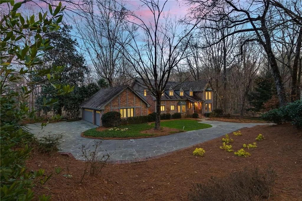 Another beautiful nighttime view of the side of the home.