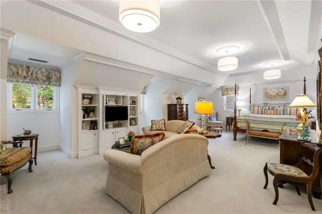Oversized primary suite with sitting area that has  fireplace and lighted trey ceiling.