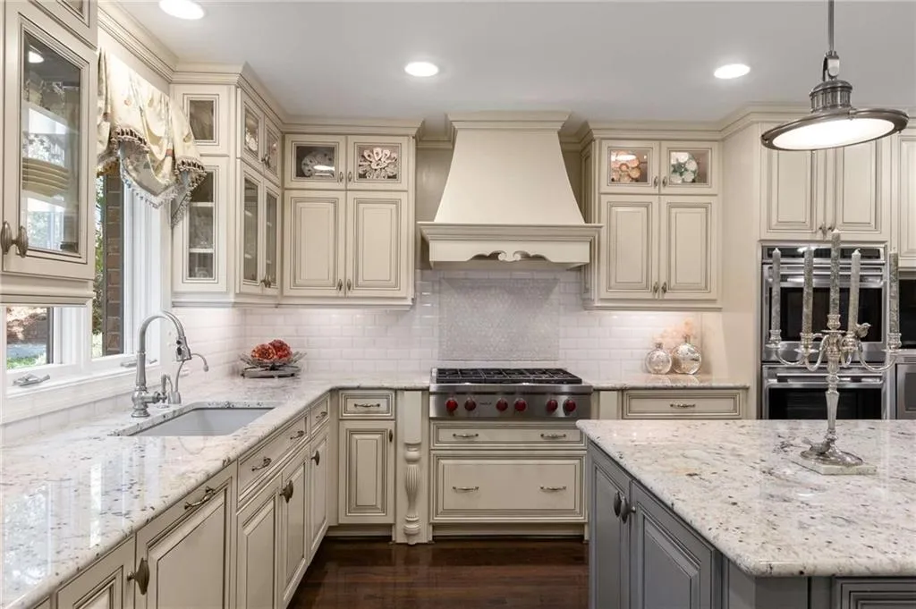 Top of line stainless appliances, 2 sinks, hanging pendant light fixtures, custom exhaust hood, and custom painted cabinets.