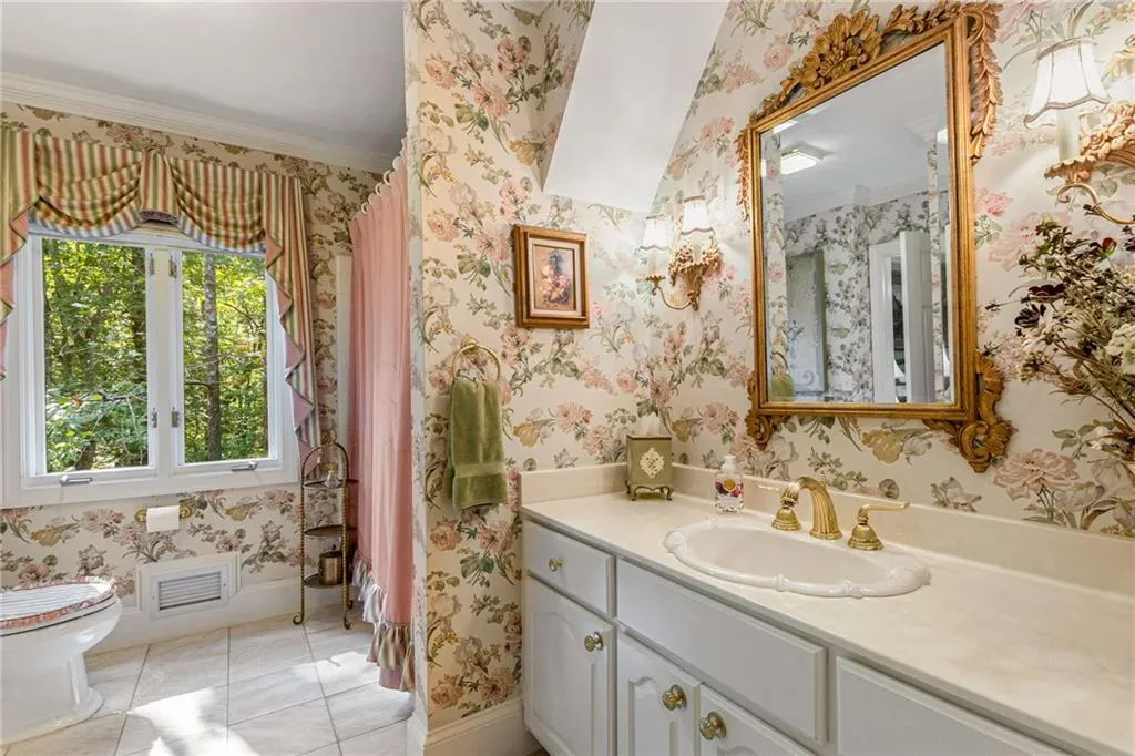Main floor bathroom with window, oversized vanity and tub / shower.