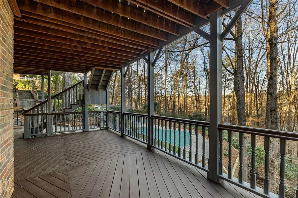 Wooden terrace overlooking private yard.