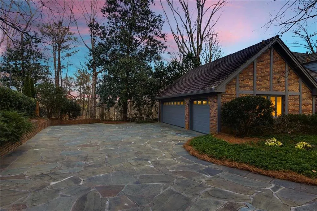 Property exterior at dusk with brick siding.