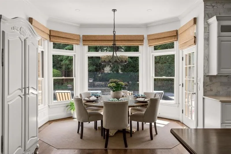 Bay window dining area featuring wood-finish flooring and a multi-pane glass door