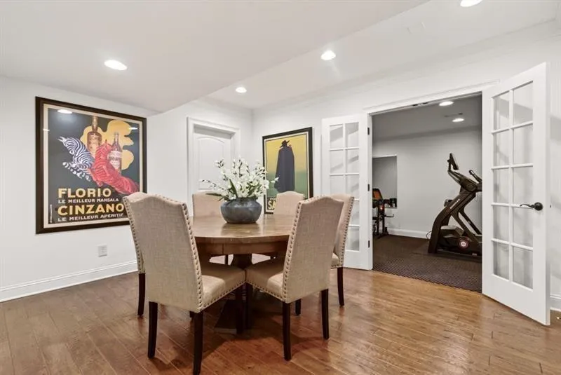 Hardwood-finish flooring extending into a spacious room with recessed lighting