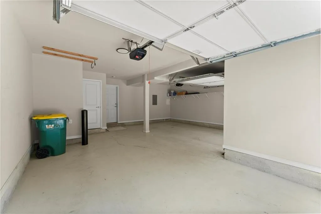 Garage featuring a garage door opener and electric panel