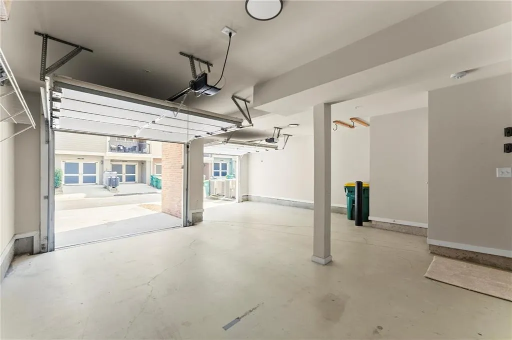Garage with baseboards and a garage door opener