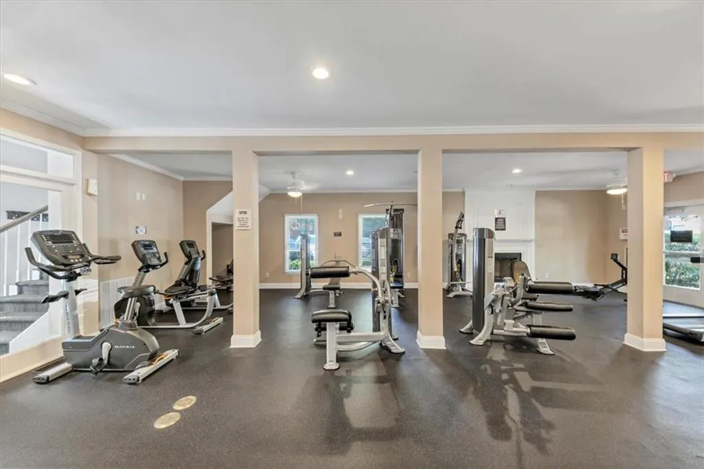 Exercise room featuring recessed lighting and ornamental molding