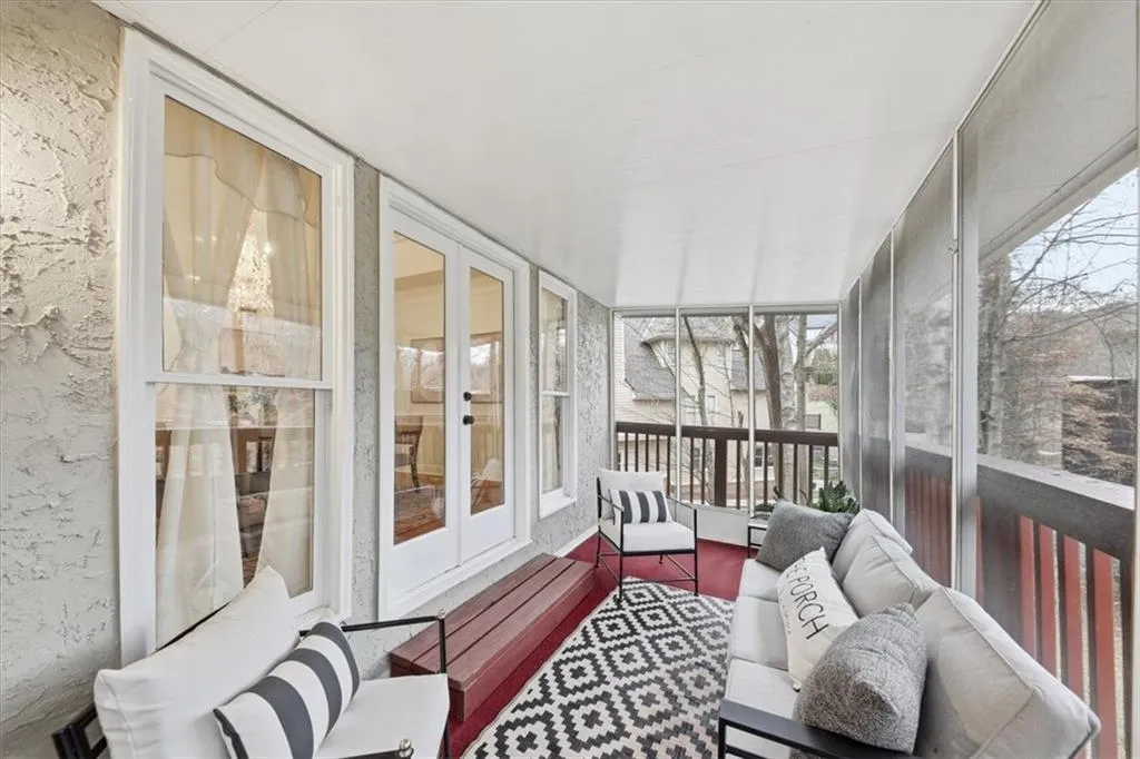 Sunroom / solarium with french doors and an outdoor living space