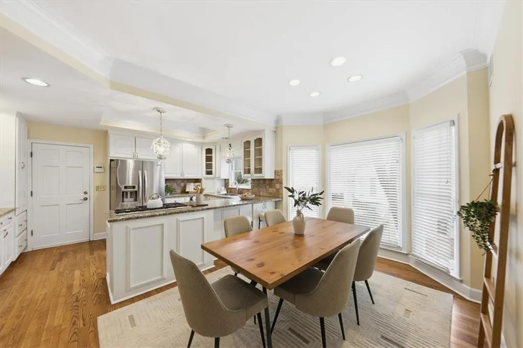 Dining area featuring ornamental molding, recessed lighting, and light wood-type flooring