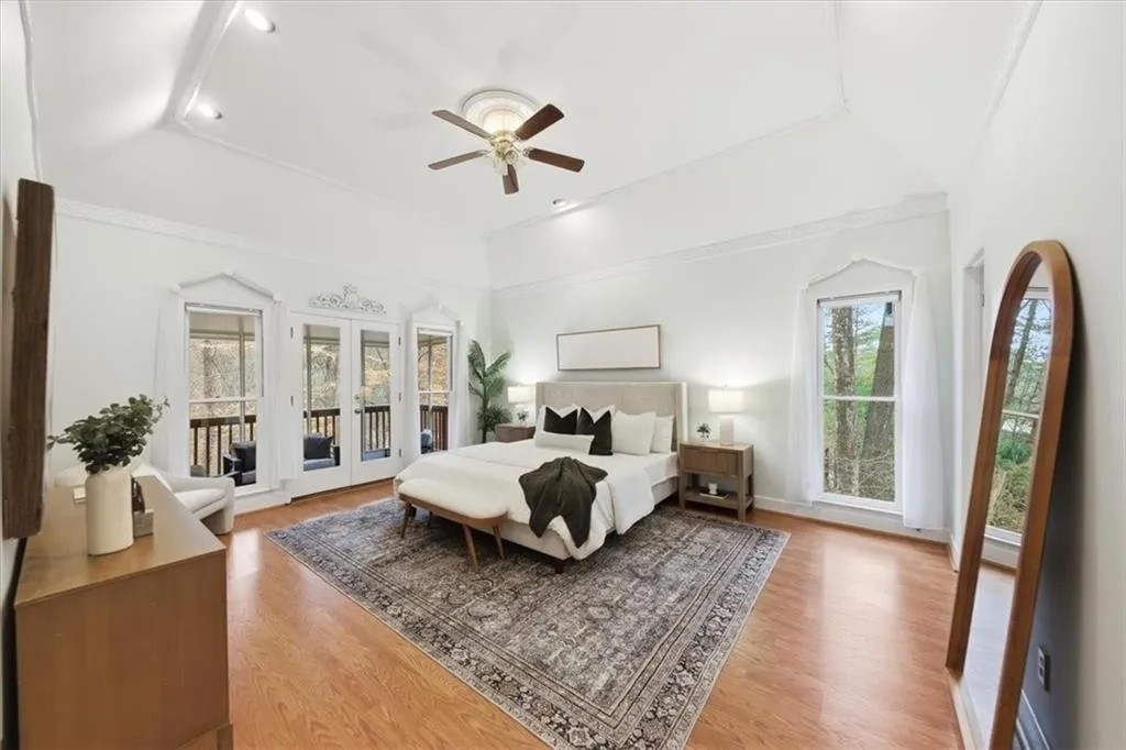 Bedroom featuring access to outside, ceiling fan, light wood finished floors, french doors, and crown molding