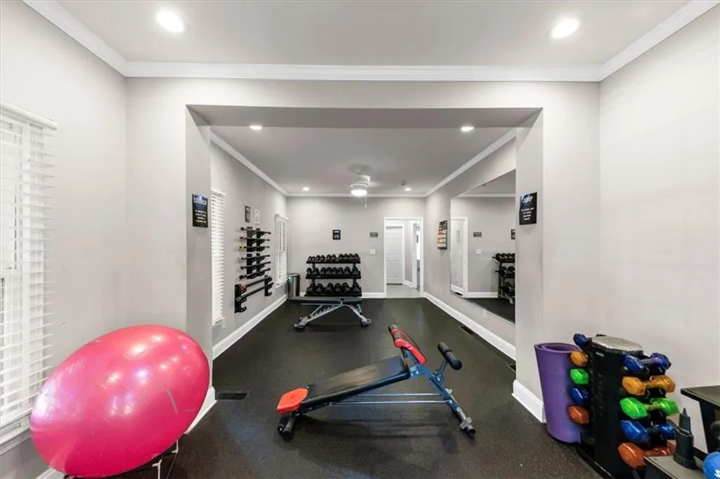 Workout area featuring recessed lighting and crown molding