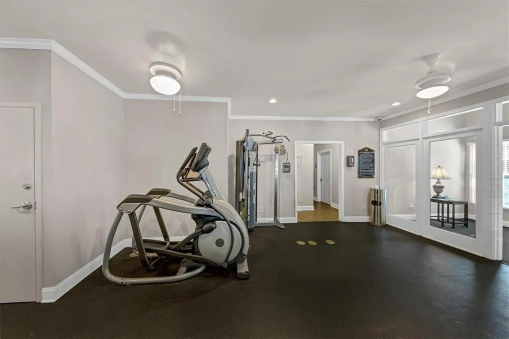 Workout room with ornamental molding and recessed lighting