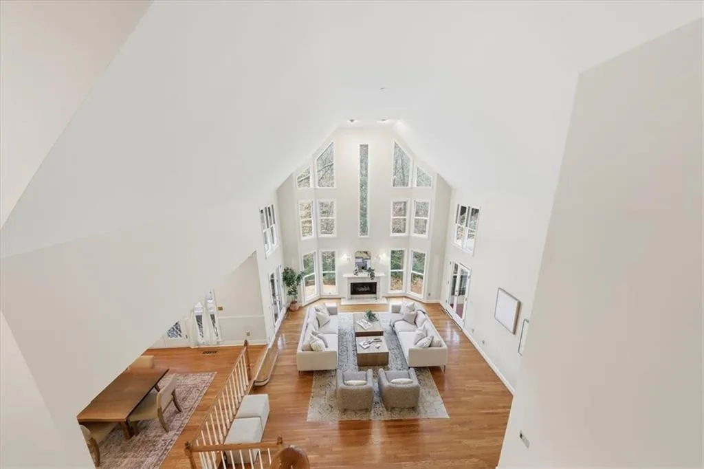 Living room featuring wood finished floors and high vaulted ceiling