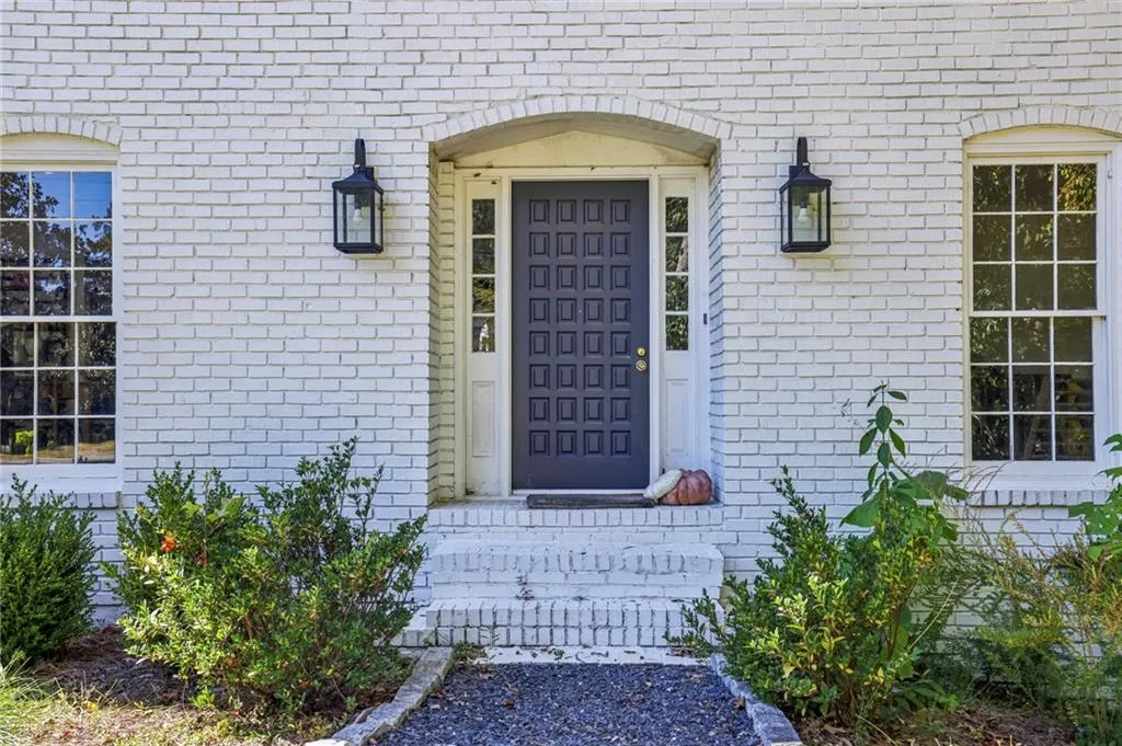 Doorway to property featuring brick siding