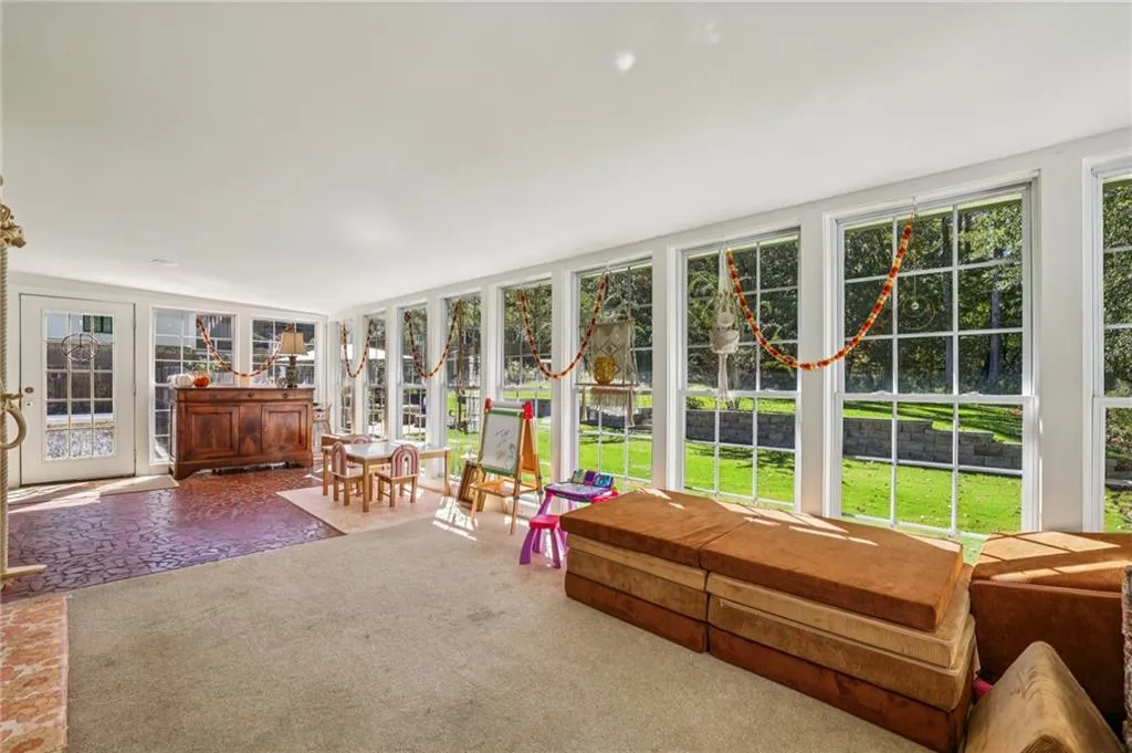 Sunroom / solarium featuring carpet floors