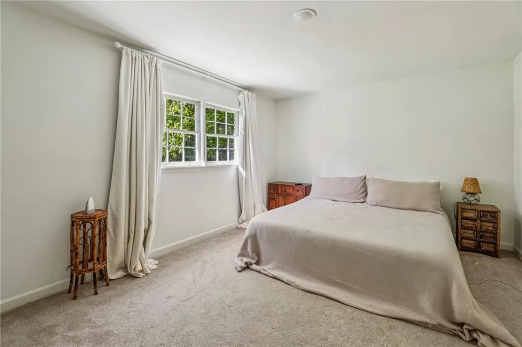 Carpeted bedroom with baseboards