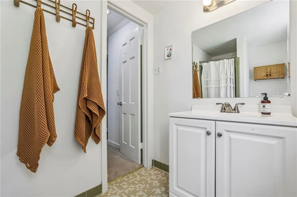 Full bath with vanity and curtained shower