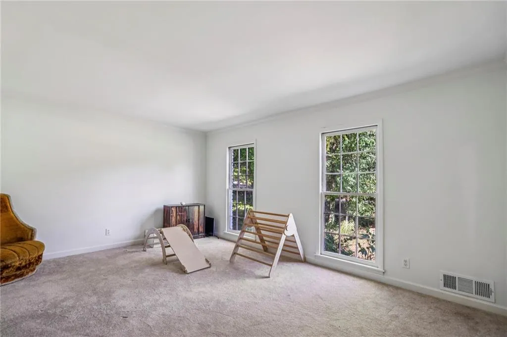 Sitting room featuring carpet floors and ornamental molding