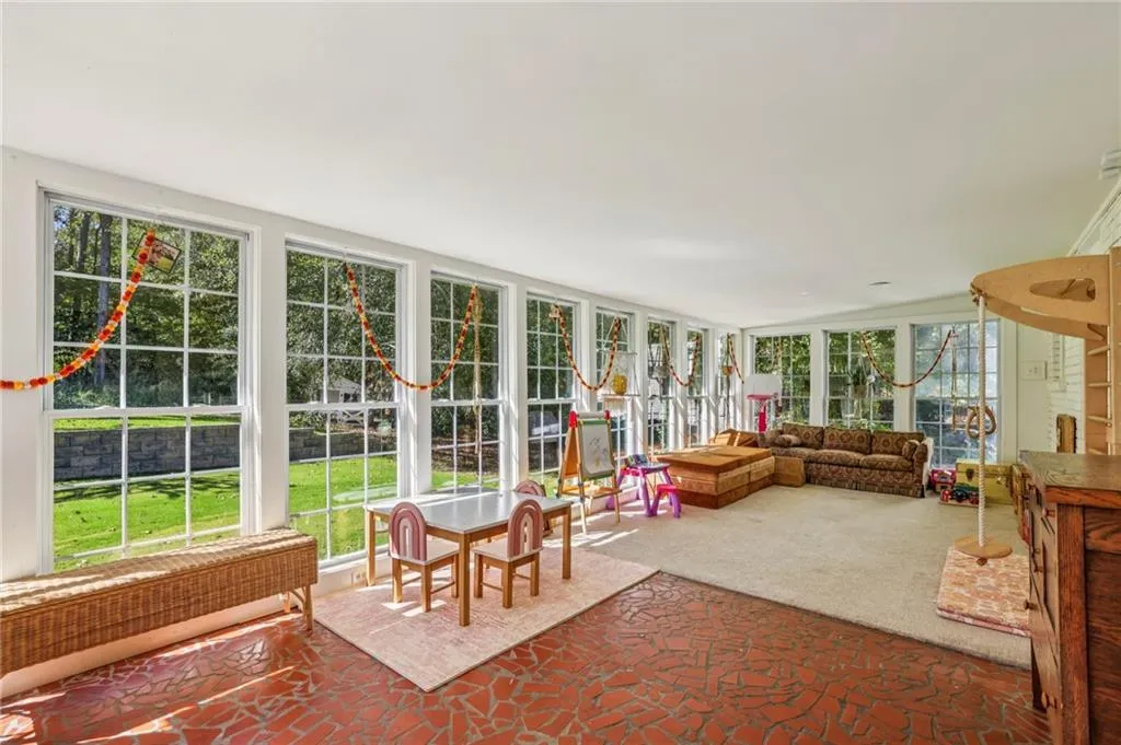 Sunroom / solarium with carpet flooring and radiator heating unit