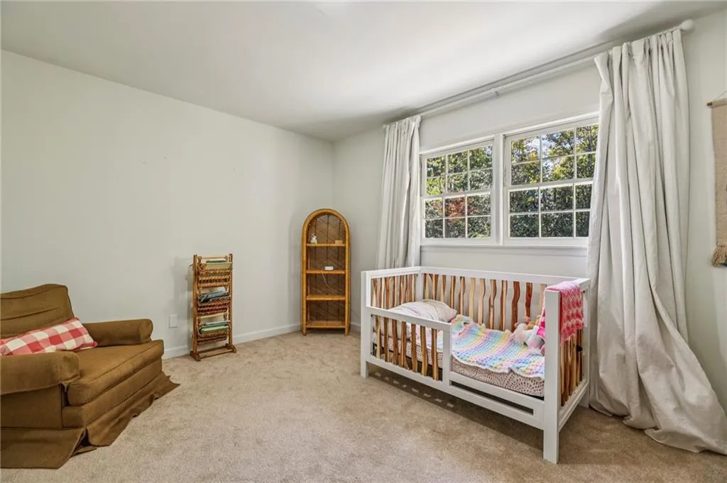 Bedroom featuring carpet flooring and a nursery area
