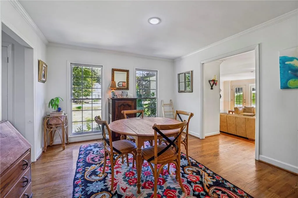 Dining area featuring ornamental molding and wood finished floors