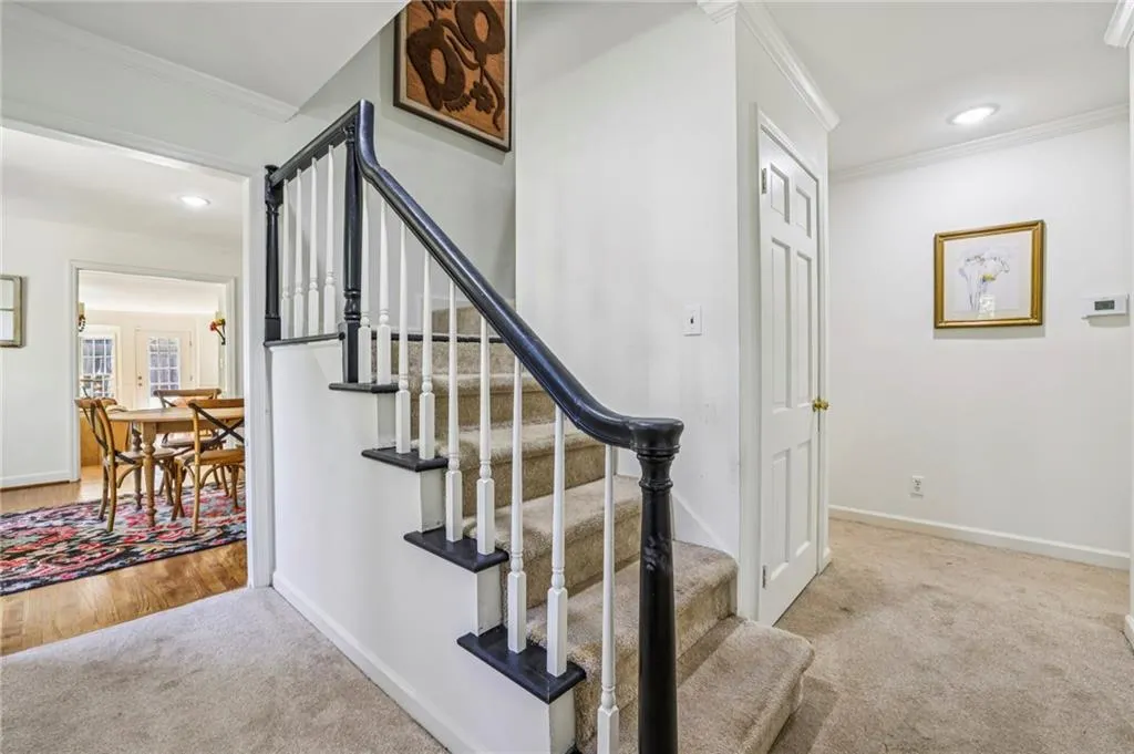 Stairway featuring crown molding, carpet flooring, and recessed lighting