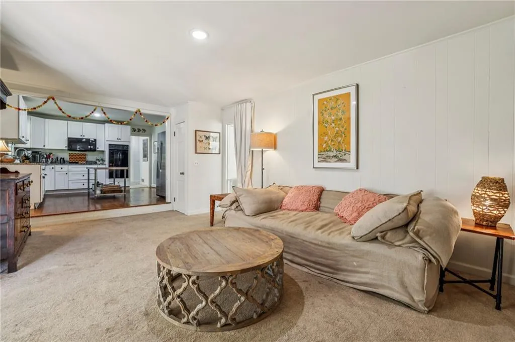 Living room with light carpet and recessed lighting