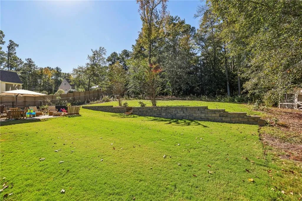 View of yard featuring a patio area and view of scattered trees