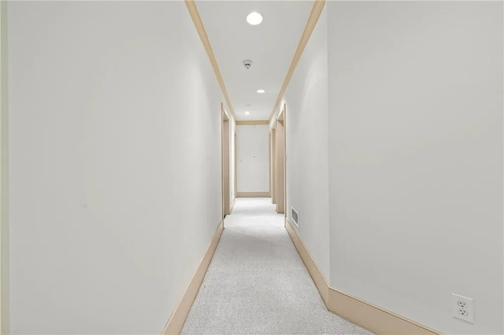 Hall with light colored carpet, recessed lighting, and ornamental molding
