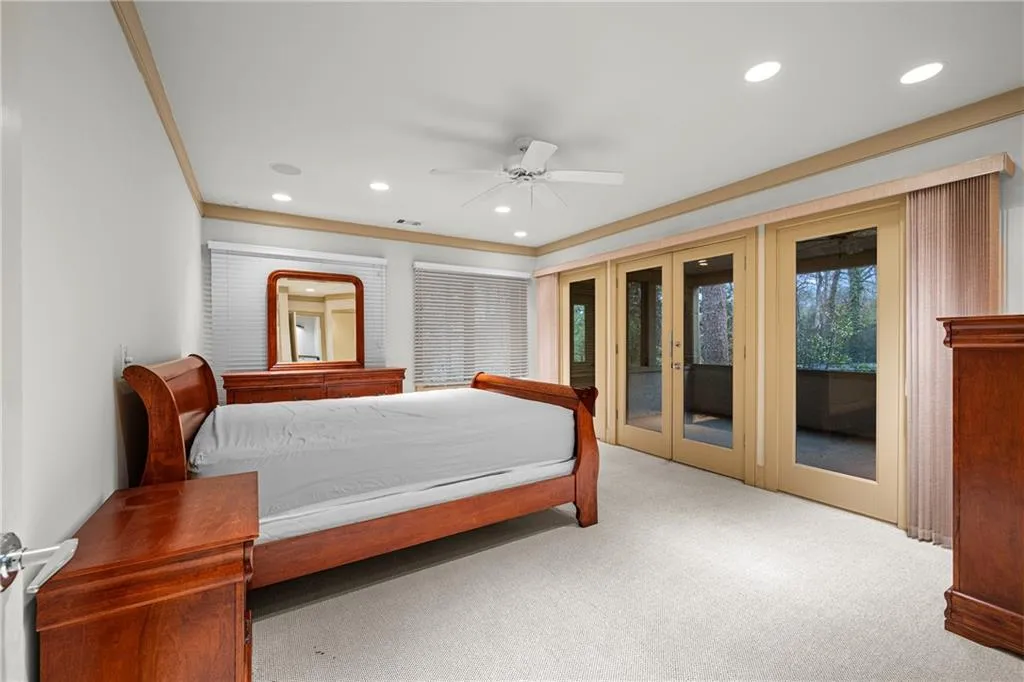 Carpeted bedroom featuring a ceiling fan, recessed lighting, french doors, access to exterior, and ornamental molding