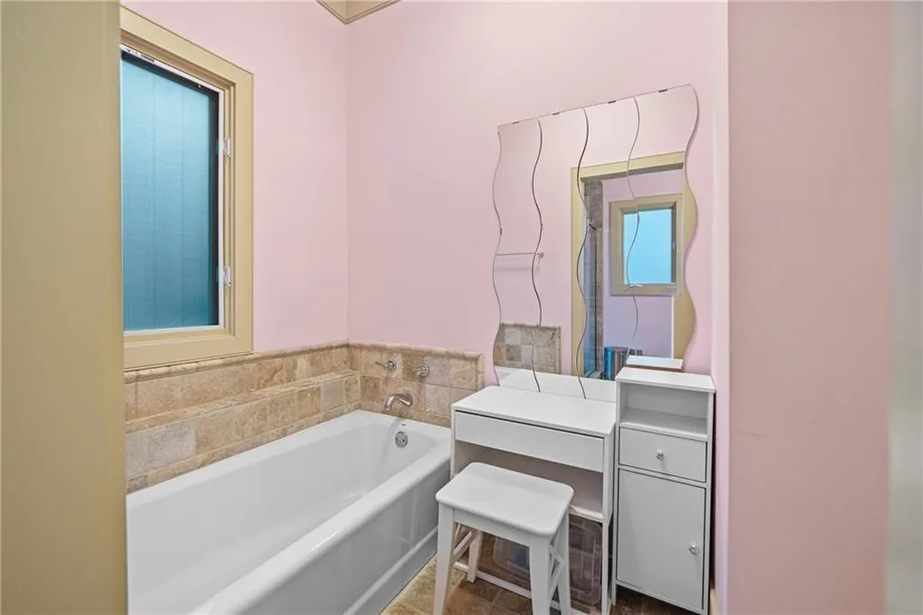 Full bath featuring a garden tub and vanity
