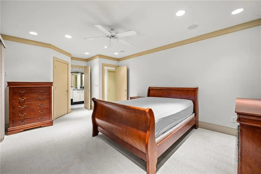 Bedroom with light carpet, a ceiling fan, recessed lighting, and crown molding