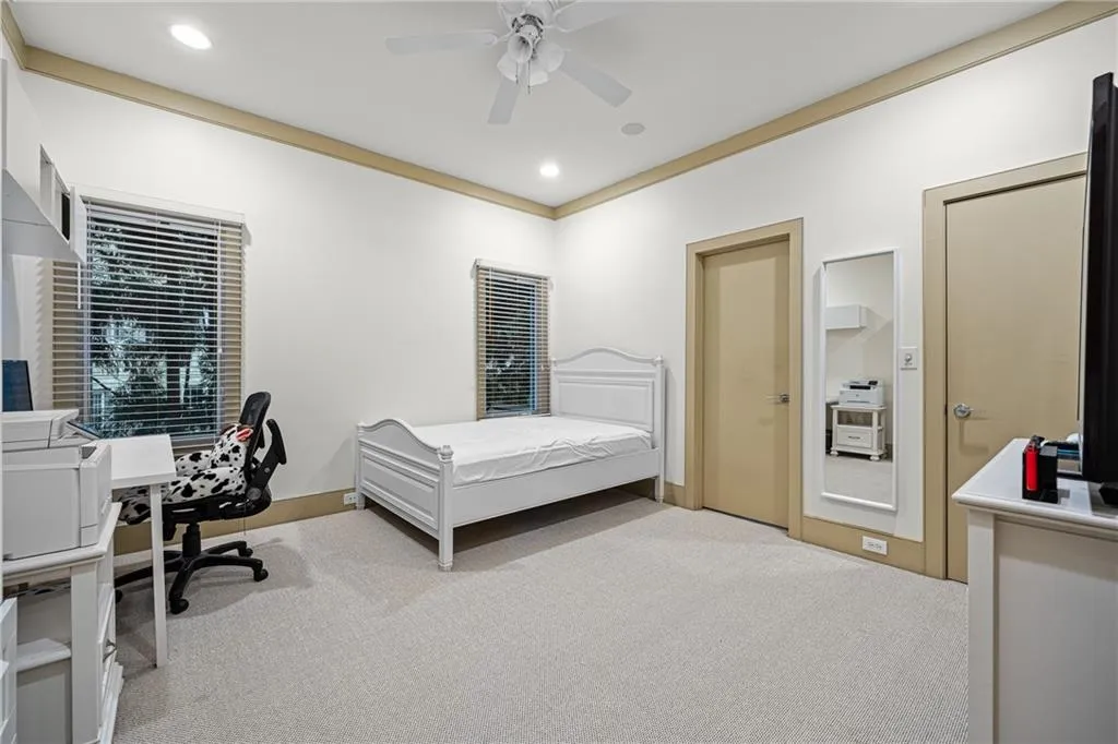 Carpeted bedroom featuring a desk, a ceiling fan, recessed lighting, and crown molding