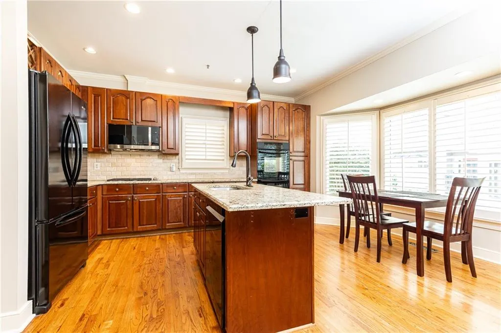 Fully equipped kitchen has a lovely breakfast nook and large bay window.