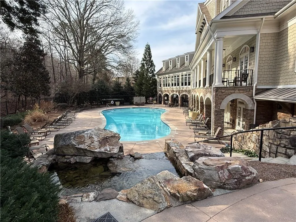 Community pool with a balcony and a patio area
