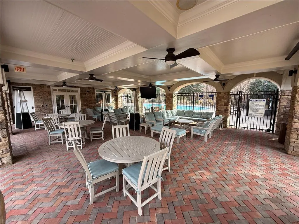 View of patio / terrace featuring a ceiling fan, outdoor dining area, and an outdoor hangout area