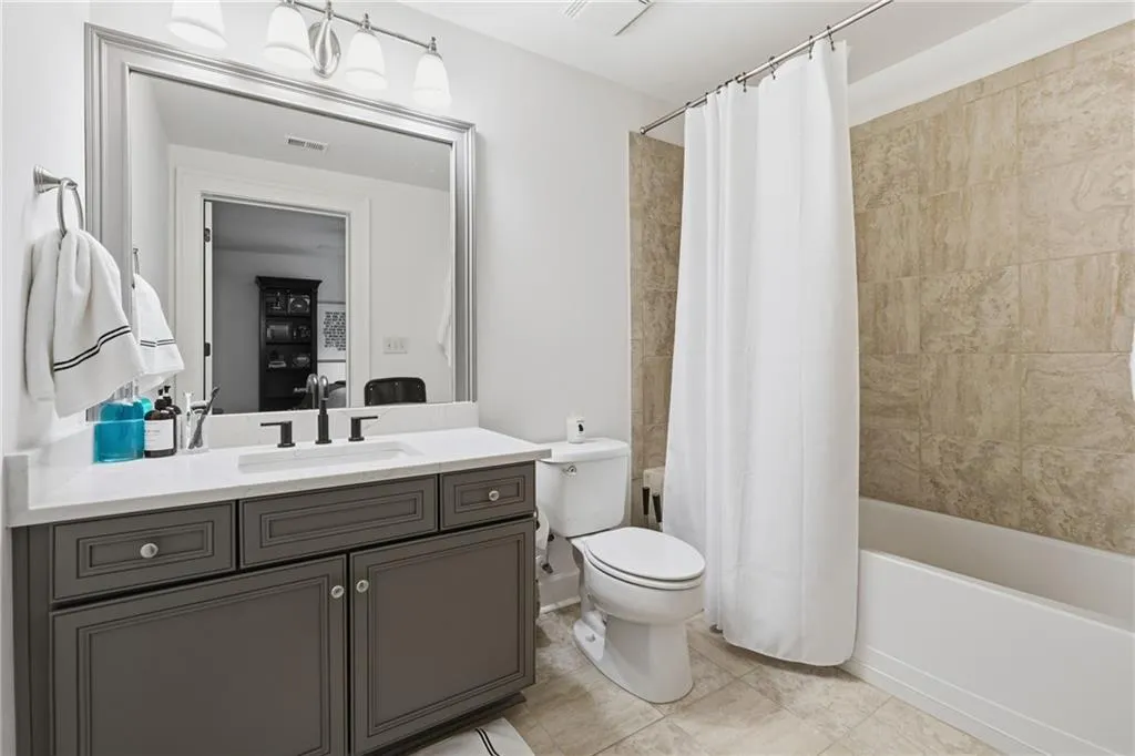 Bathroom featuring shower / tub combo and vanity