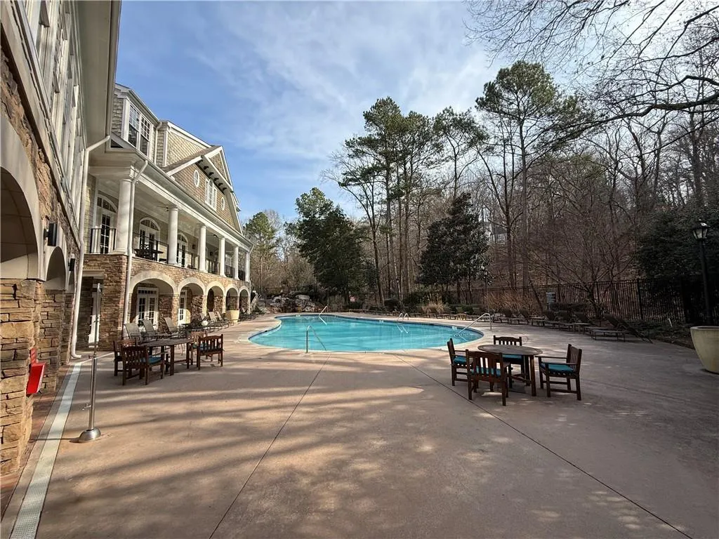 Community pool with a patio and a balcony