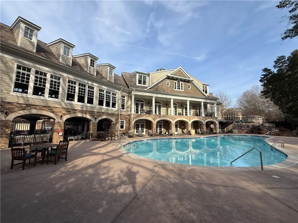 Community pool featuring a patio area and a balcony