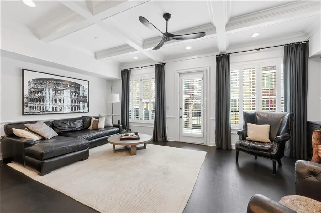 Living area with coffered ceiling, beamed ceiling, recessed lighting, ceiling fan, and crown molding