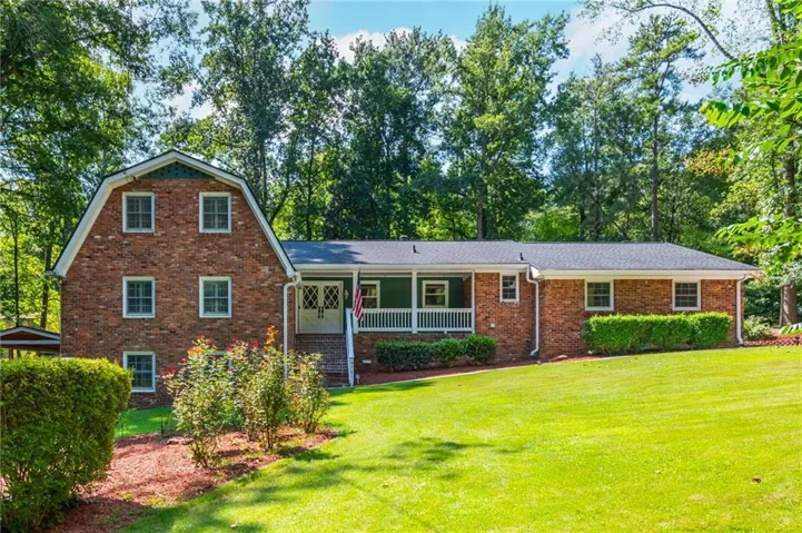 Brick exterior with a gambrel roof and dormer windows