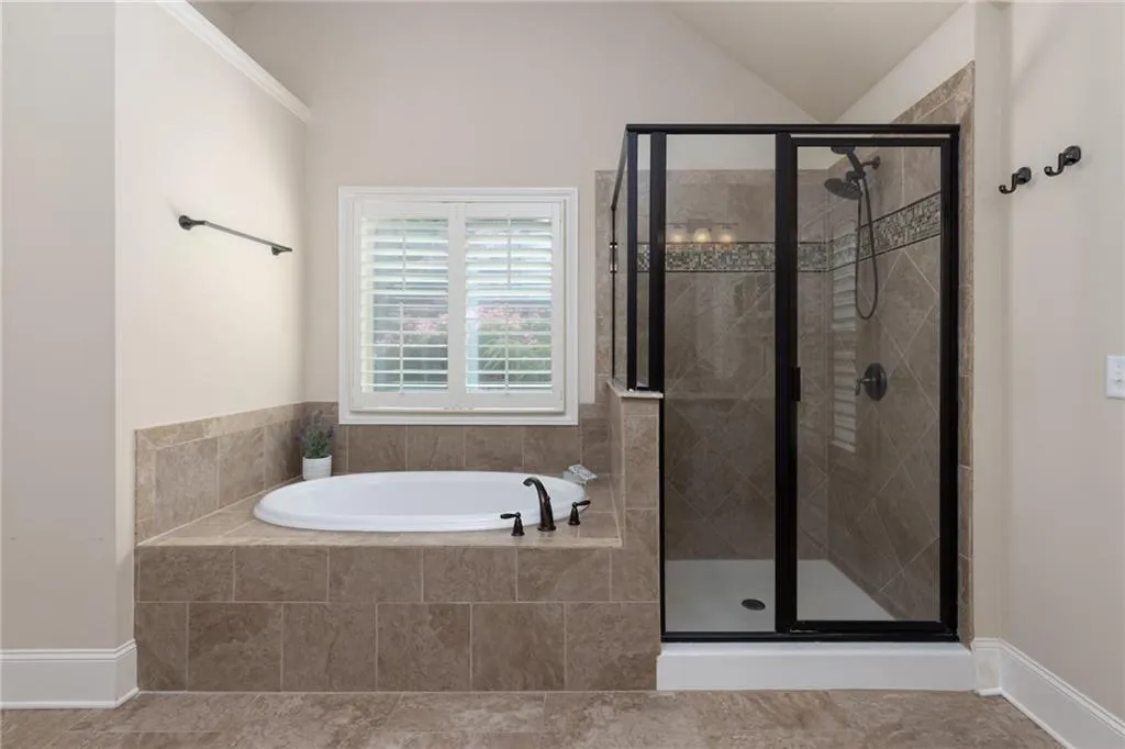 Bathroom with tile floors and independent shower and bath