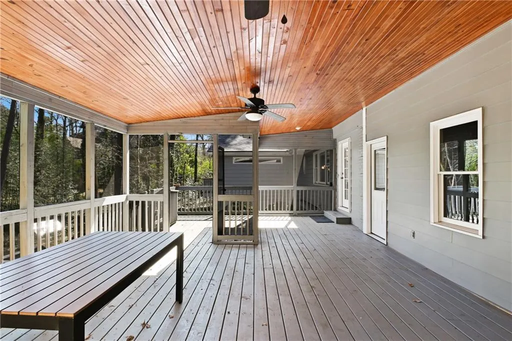 Unfurnished sunroom with wooden ceiling and a ceiling fan