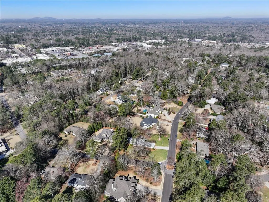 Aerial view featuring a forest view and a residential view