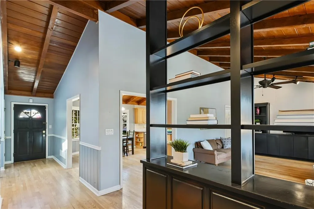 Entrance foyer with light wood-type flooring, wood ceiling, and beamed ceiling