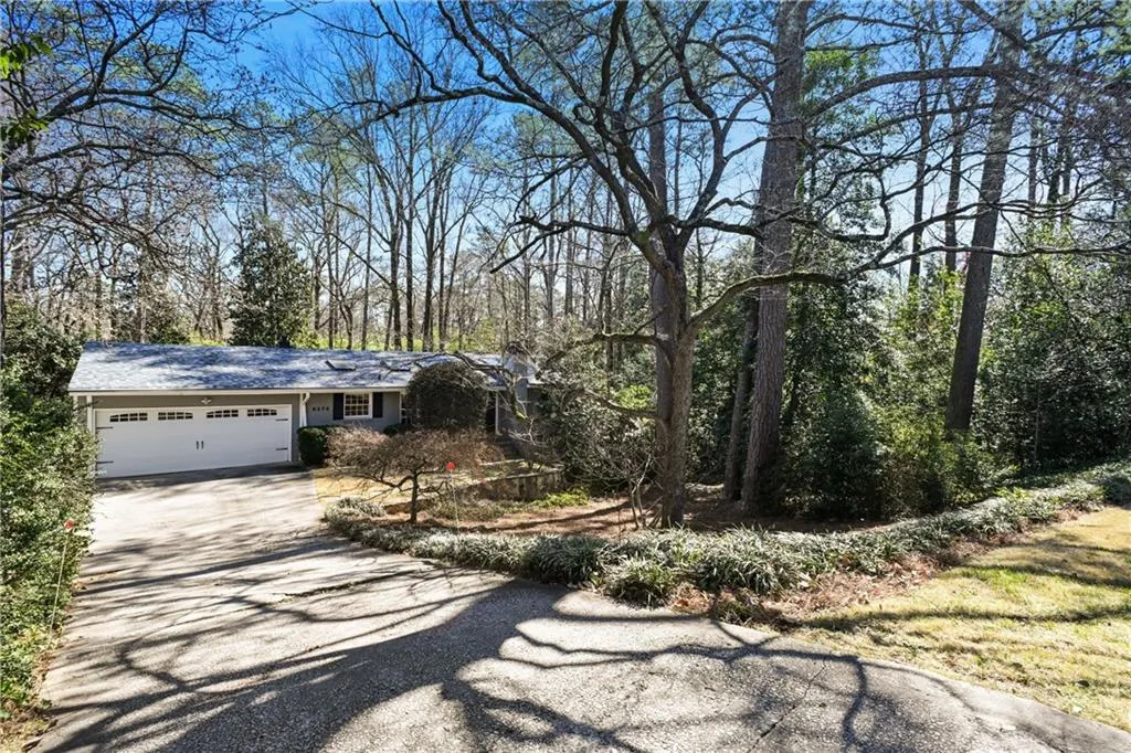 View of front of property with a garage and driveway