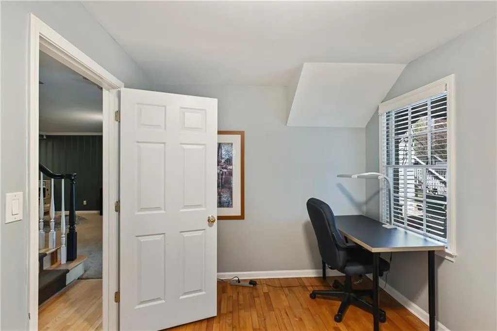 Office area with baseboards and wood finished floors
