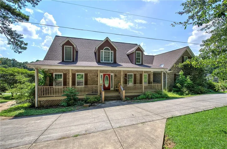 Great cape cod style home with lots of paved parking and turn around area.