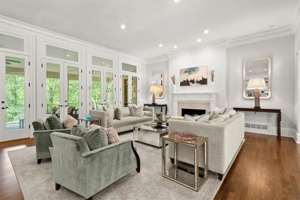 Living room featuring dark wood-type flooring, ornamental molding, and french doors Living room featuring dark wood-type flooring, ornamental molding, and french doors